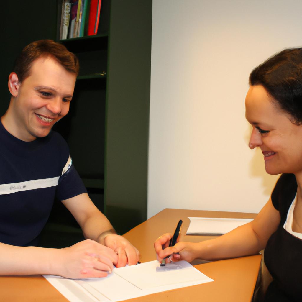 Person signing loan documents, smiling